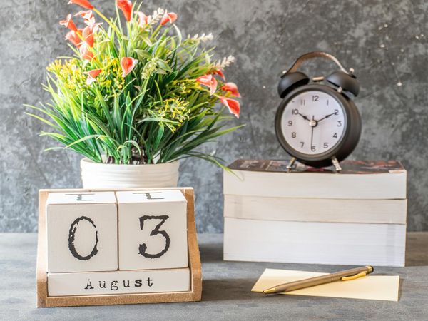 A calendar icon next to a clock, symbolizing daily routine.
